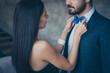 © deagreez - Cropped photo of two chic people couple guy looking lady who fixing taking care of blue stylish bow tie best pair at birthday party wear classy formalwear suit dress indoors
