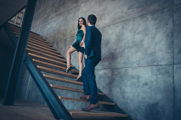 Sticker - Full length rear view photo of tender trendy couple guy lady erotic desire climbing up second floor holding hands new house excursion wear formalwear suit short dress loft indoors