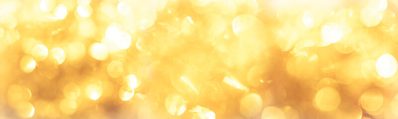 golden color blurred abstract background. yellow bokeh christmas blurred beautiful shiny Christmas lights.