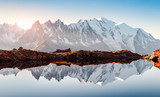 Fototapeta Góry - Incredible view of clear water and sky reflection on Chesery lake (Lac De Cheserys) in France Alps. Monte Bianco mountains range on background. Landscape photography, Chamonix.