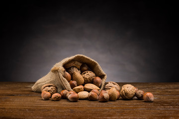 Wall Mural - mix of dried fruits in jute gab on wooden table