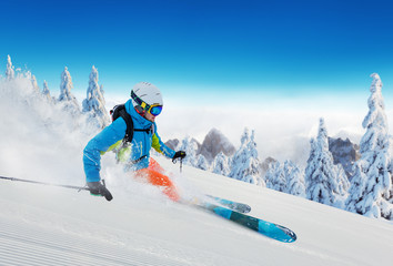 Wall Mural - Young man skiing in Alps