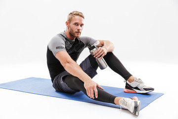 Wall Mural - Portrait of a tired fit sportsman resting after work out isolated