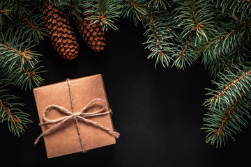 Wall Mural - A frame of fir branches and  gift paper box tied with twine. Christmas card blank.