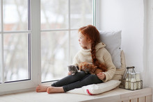 Little Girl Sitting On Windows-sill With Little Kittens