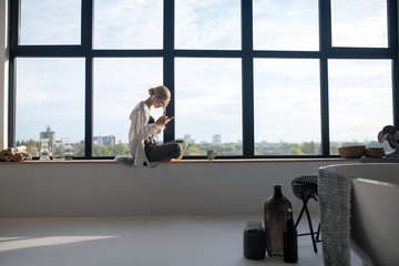 Woman spending morning at home in her spacious apartment