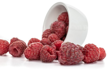 Wall Mural - Lot of whole fresh crimson raspberry in ceramic stewpan isolated on white background