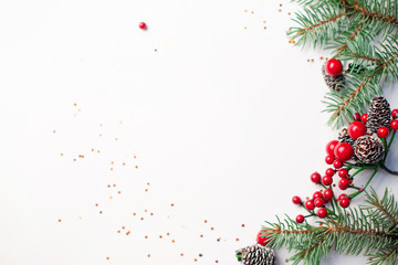 Christmas composition flatlay. Spruce branches, red berries on white background with space for text