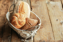 Bread In A Basket On A Black Background. Assorted Baking In A Metal Basket. Place For Recipe And Text. Background With Rolling Pin And Flour. Rye Bread And Baguette With Seeds. Buckwheat Bread 