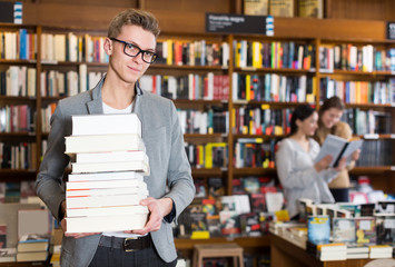 Wall Mural - guy with stack of books in hands