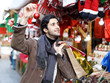 © JackF - Happy young man with Christmas toys at fair outdoor