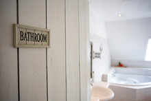 Closeup Bathroom Door With Sign Bathroom Shallow Depth Of Field, Blurred Background, White Colors