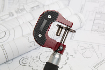 Wall Mural - measuring a part with a micrometer in the background