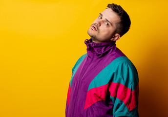 Wall Mural - Style man in 90s tracksuit on yellow background