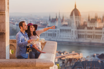young couple searching right direction on map from the point from fisherman bastion in budapest with