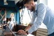 © opolja - Man Working At Laptop In Contemporary Office