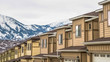 Panorama Townhouses with wall sidings and white garage doors against snowy mountain