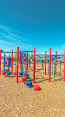 Wall Mural - Vertical frame Park with vivid childrens playground and pavilion picnic area overlooking lake