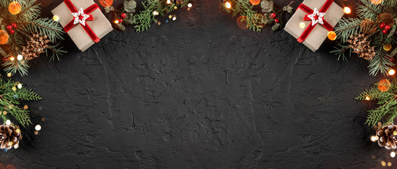 Wall Mural - Christmas gift boxes on holiday background with Fir branches, pine cones. Xmas and Happy New Year theme, bokeh, sparking, glowing. Flat lay, top view, space for text