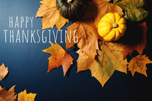 Happy Thanksgiving Day With Maple Leaves And Pumpkin On Blue Background