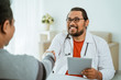© Odua Images - portrait of smiling doctor shaking hand with patient in his office