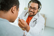© Odua Images - portrait of crazy doctor using headphone instead of stethoscope to check his patient