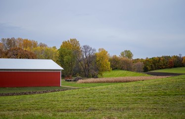 Red building on farm land in Autumn