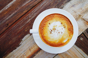 White hot coffee mugs placed on a wooden floor with the morning fresh weather on the mountain