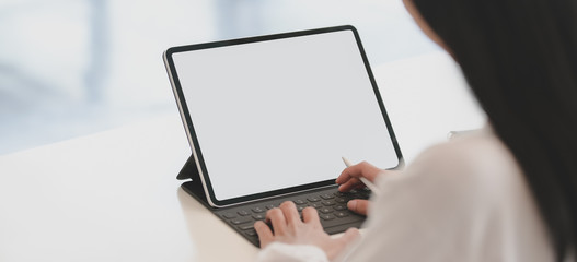 Canvas Print - cropped shot of young businesswoman working on her project while using tablet