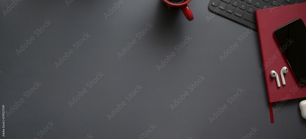 Overhead shot of dark luxury workspace with red notebooks and copy space with office supplies - obrazy, fototapety, plakaty 