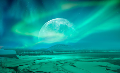 northern lights (aurora borealis) in the sky over tromso with full moon, norway 