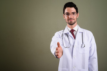 Wall Mural - Portrait of young handsome man doctor with eyeglasses