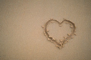 Heart drawn on beach sand