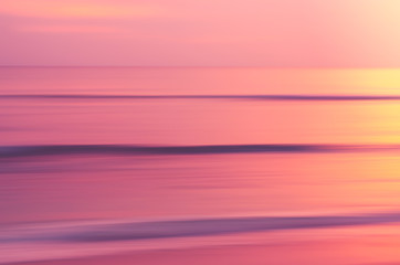 Copy space of soft sand sea and blur tropical beach with sunset sky and cloud abstract background.