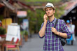 © Ranta Images - Portrait of young handsome tourist man using phone in the streets