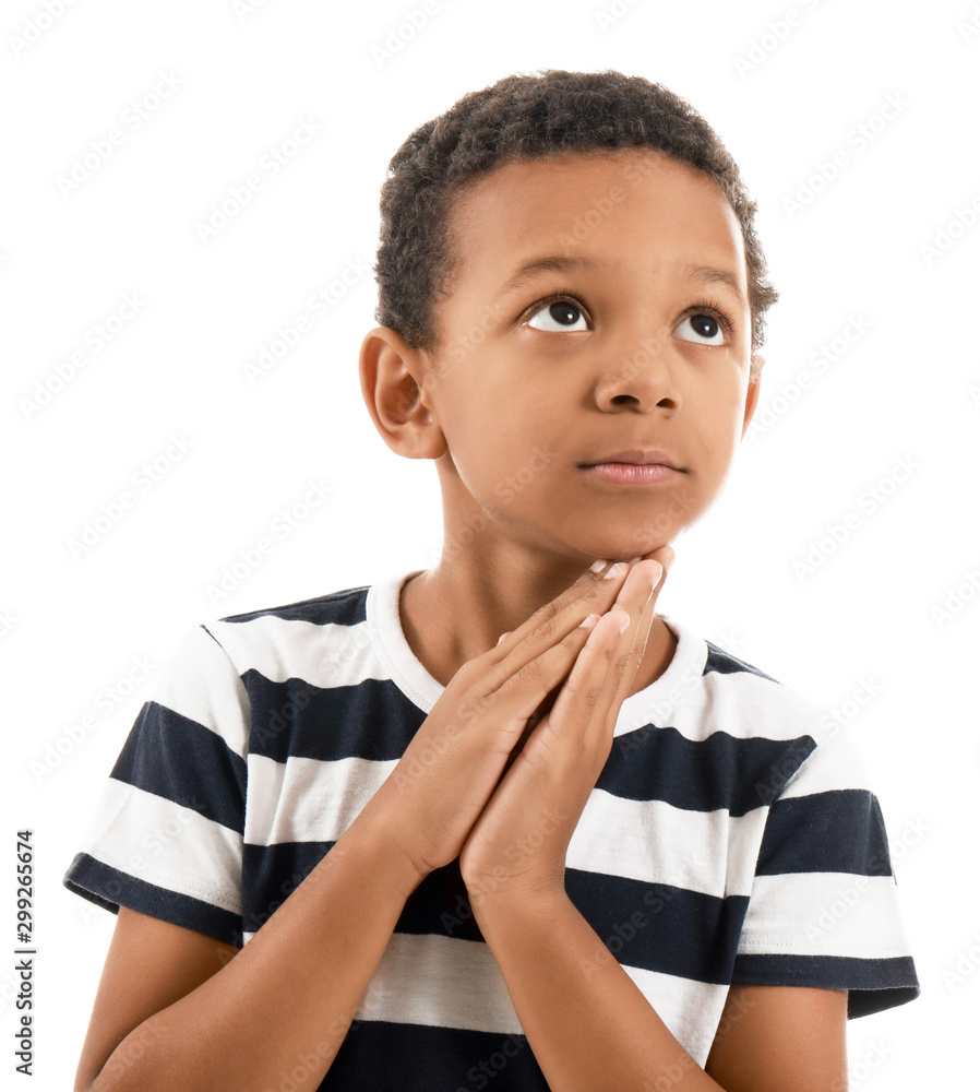 Praying African-American boy on white background