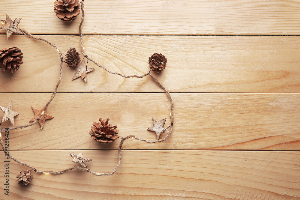 Beautiful Christmas lights with decor on wooden background