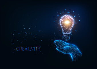 Wall Mural - futuristic idea, creativity concept with glowing low polygonal light bulb and human hand.