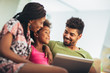 © Mediteraneo - African american family using laptop in the living room.