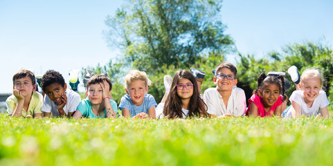 Portrait of children who are posing lying in the park