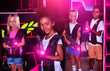 © JackF - Teenager girl with laser pistol posing in laser tag labyrinth