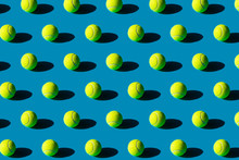 Geometric Pattern Of Tennis Balls With Strong Shadows On A Blue Background