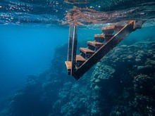 Closeup Shot Of A Rusted Metal Stairway Under The Sea