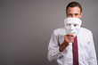 © Ranta Images - Portrait of handsome businessman against gray background