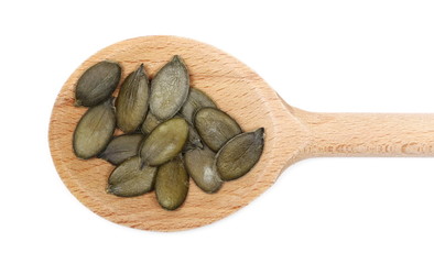 Wall Mural - Pumpkin seeds in wooden spoon isolated on white background, top view