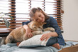© New Africa - Happy girl with cute Akita Inu dog near window indoors. Little friends