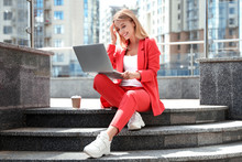 Beautiful Businesswoman With Laptop Sitting On Stairs Outdoors