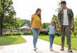 © New Africa - Man in military uniform and his family walking at sunny park