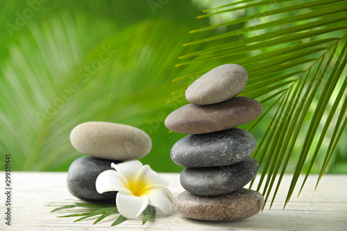 Cuadros en Lienzo Composition with stones on table against blurred background