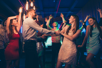 Sticker - Lets dance my love. Portrait of positive cheerful couple students have wedding party dance on discotheque with lots people crowd wearing formalwear dress skirt in spotlight